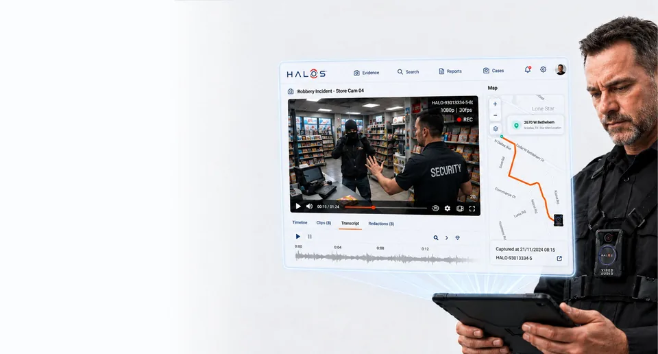 A security guard wearing a HALOS camera on his chest, reviewing incident footage on a tablet
